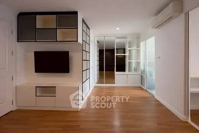 Modern living room with sleek built-in storage and wooden flooring