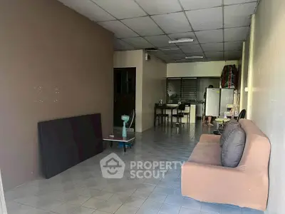 Cozy living room with sofa and open kitchen layout, ideal for modern living.