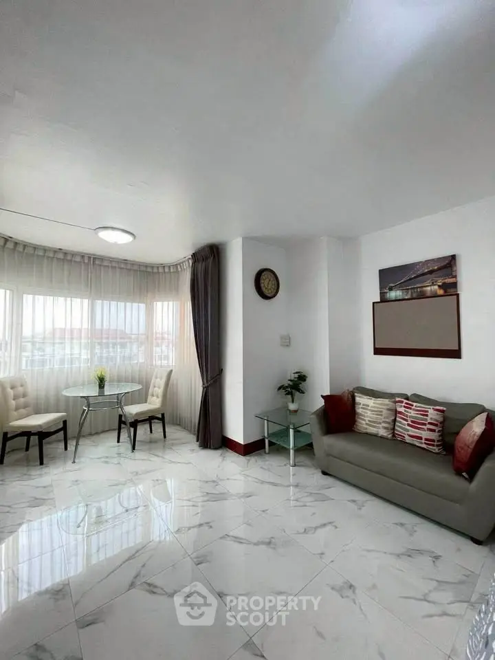 Spacious living room with modern decor and large windows for natural light.