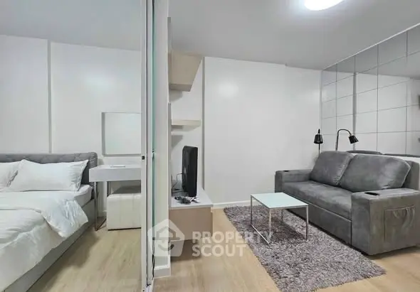 Modern studio apartment with cozy living area and stylish bedroom.