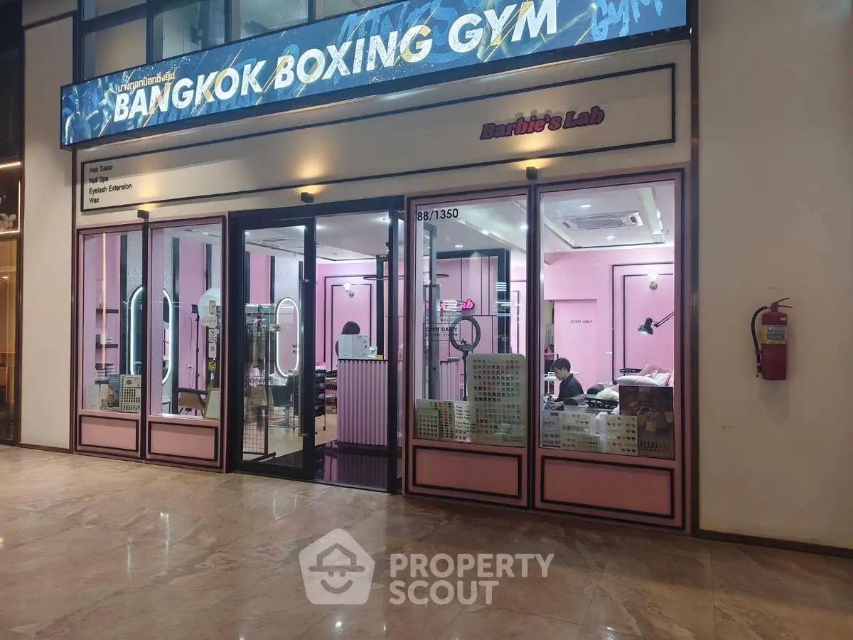 Chic commercial space with pink interior and modern design in a bustling shopping area.