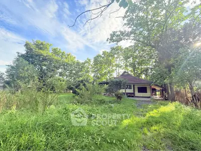 Charming countryside home surrounded by lush greenery and trees, offering a serene and private retreat.