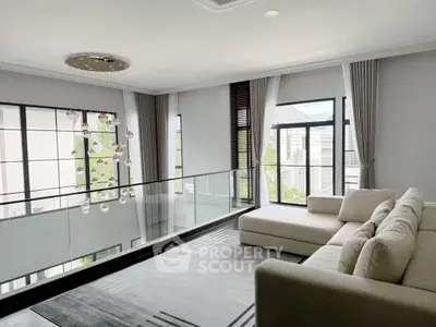 Luxurious modern living room with large windows and elegant chandelier