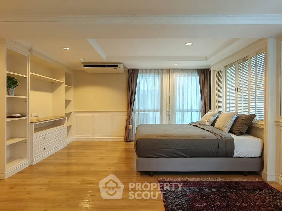 Spacious bedroom with elegant decor and natural light