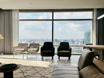 Luxurious living room with panoramic city view and stylish modern furniture.