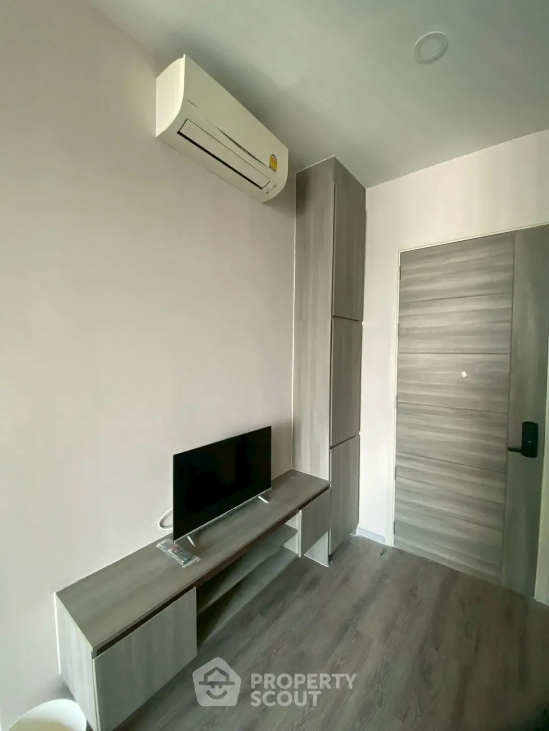 Modern minimalist room with air conditioning and sleek wooden furniture