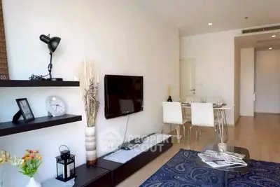 Modern living room with sleek decor and dining area, featuring a wall-mounted TV and stylish shelving.