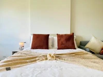 Cozy bedroom with stylish decor and plush pillows, perfect for relaxation and comfort.