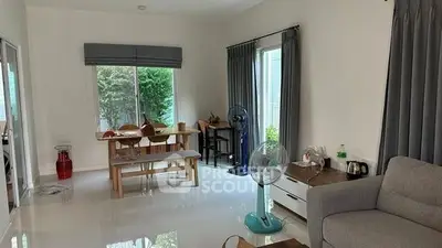 Spacious living room with modern decor and large windows for natural light.