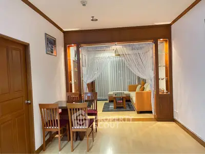 Spacious living room with elegant wooden decor and cozy seating area, perfect for relaxation and entertainment.