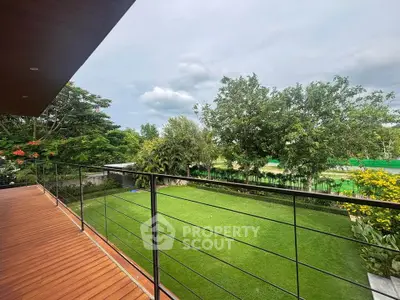 Spacious balcony overlooking lush green garden with serene views, perfect for relaxation and outdoor enjoyment.