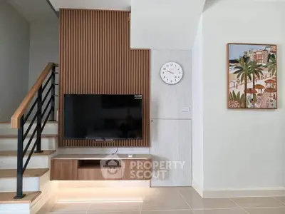 Modern living room with stylish TV setup and wooden accents