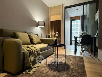 Stylish modern living room with cozy sofa and dining area in open layout apartment.