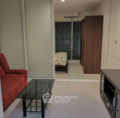 Cozy studio apartment with modern furnishings and sliding glass doors