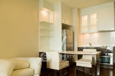Modern kitchen with sleek design and dining area in a stylish apartment