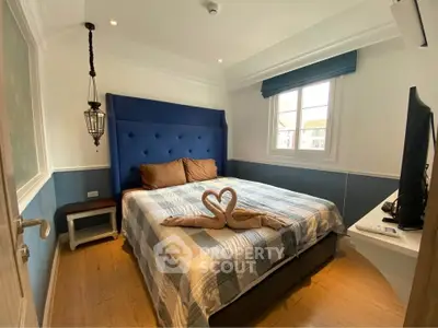 Cozy bedroom with stylish decor and natural light, featuring a comfortable bed and elegant lighting.