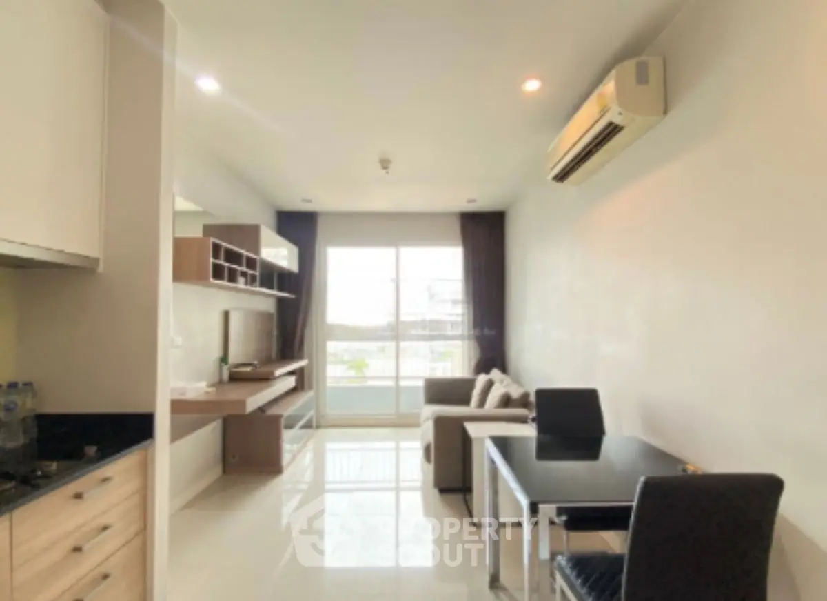 Modern living room with sleek furniture and large window for natural light.