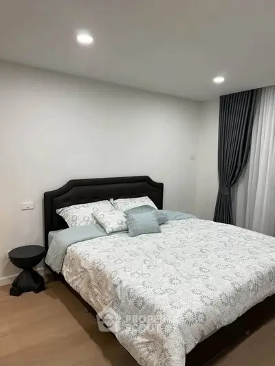 Cozy bedroom with elegant decor and soft lighting, featuring a comfortable bed and stylish curtains.