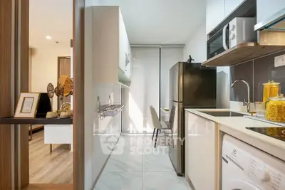 Modern kitchen with sleek appliances and stylish decor in a contemporary apartment.