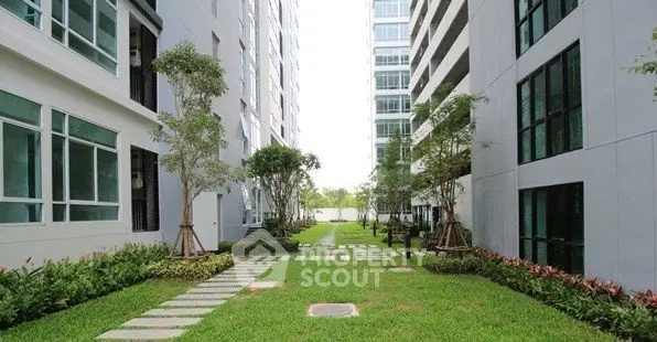 Modern apartment buildings with lush green garden and pathway