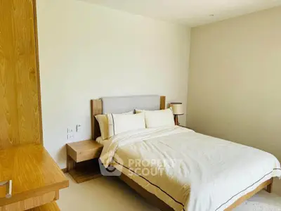 Modern bedroom with wooden furniture and neutral tones