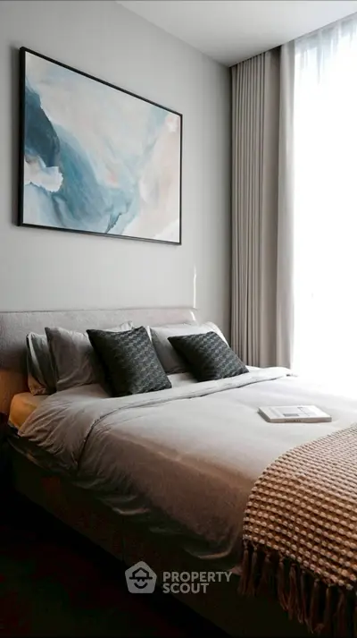 Elegant bedroom with modern decor and large window for natural light