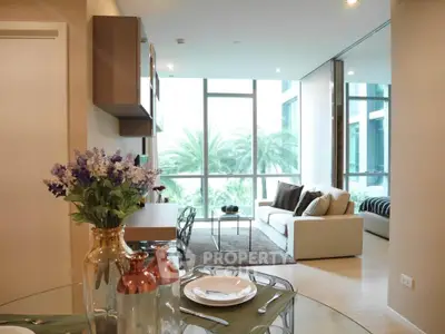 Modern living room with large windows and stylish decor, offering a bright and inviting atmosphere.