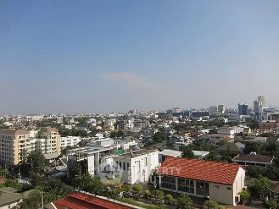 Stunning cityscape view showcasing urban residential buildings under a clear blue sky.