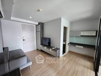 Modern living room with sleek furniture and wooden flooring in a stylish apartment.