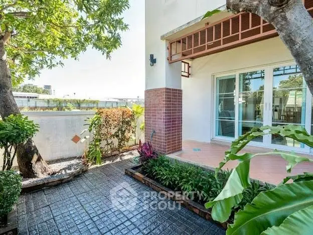 Charming garden view with lush greenery and patio in modern residential property.