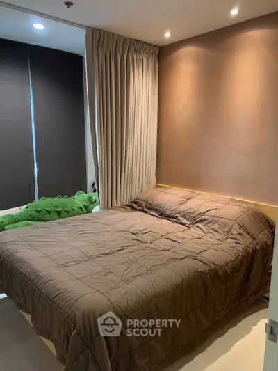 Cozy bedroom with modern decor and soft lighting, perfect for relaxation.
