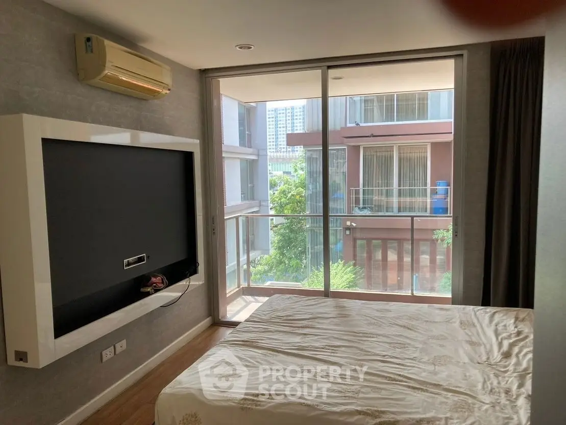 Modern bedroom with balcony view in urban apartment