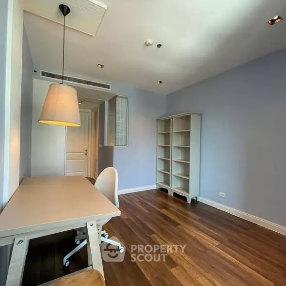 Spacious study room with wooden flooring and modern furniture