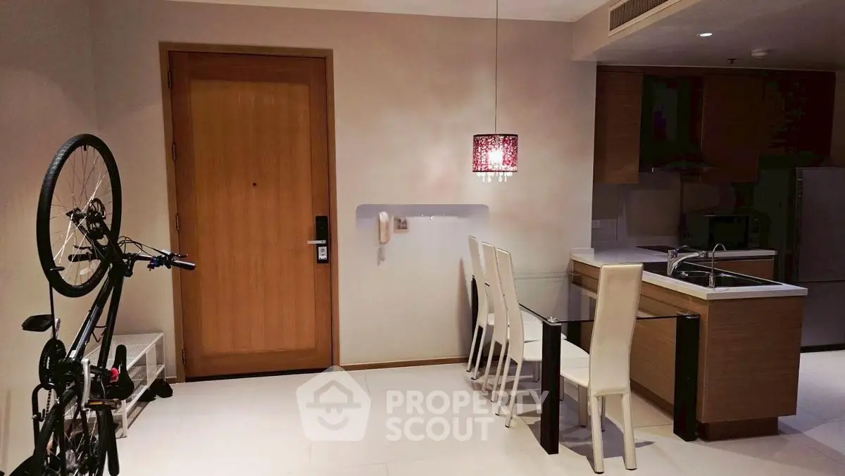 Modern kitchen with dining area and bicycle storage in stylish apartment