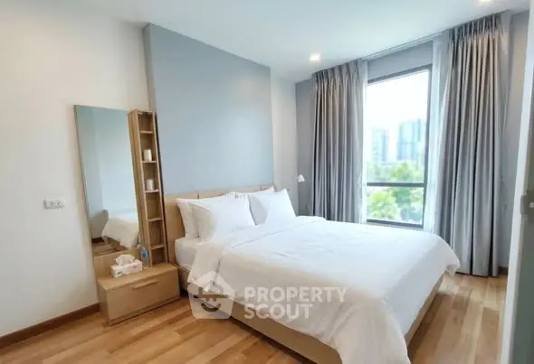 Bright and airy bedroom with large window and modern decor