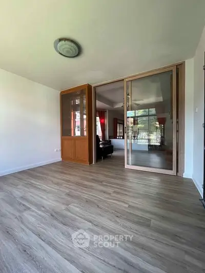 Spacious living room with wooden flooring and sliding glass doors