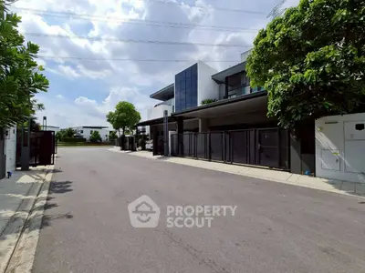 Modern residential street with contemporary houses and lush greenery