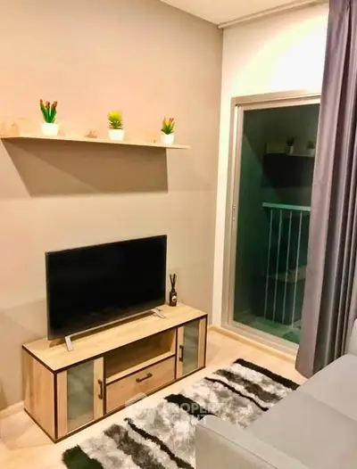 Cozy living room with modern decor and balcony access in stylish apartment.