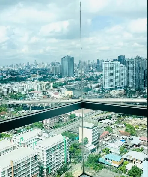 Stunning cityscape view from a high-rise building corner unit with expansive windows.