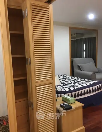 Cozy bedroom with wooden furniture and modern decor