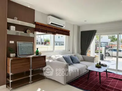 Modern living room with stylish decor and large window offering natural light