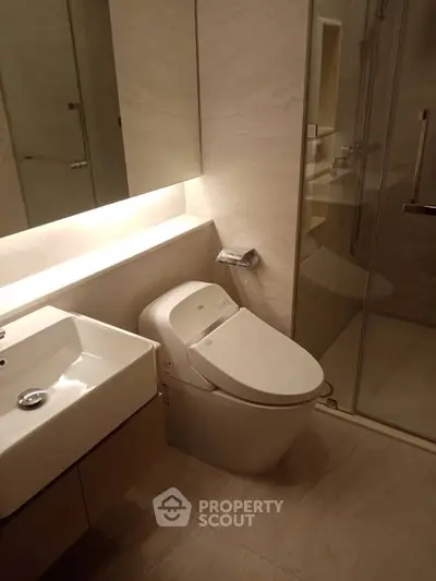 Modern bathroom with sleek fixtures and glass shower enclosure