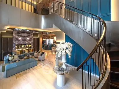 Luxurious modern living room with elegant staircase and stylish decor