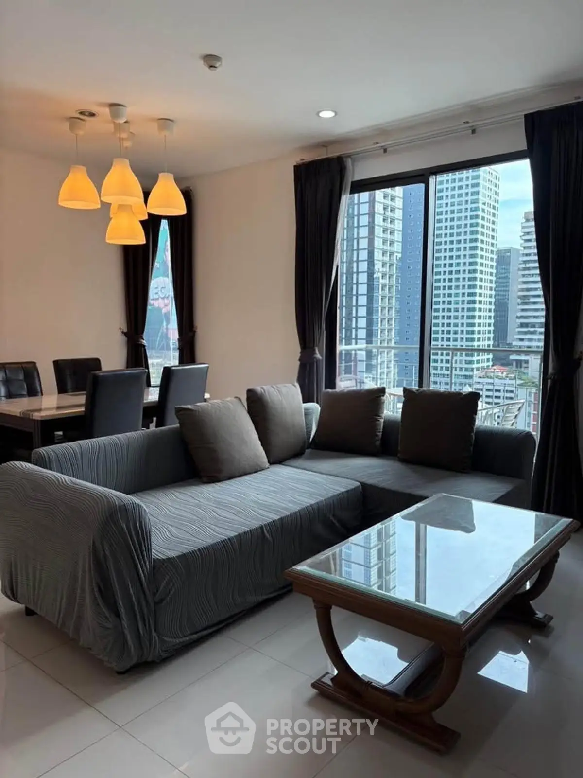 Spacious living room with city view and elegant dining area