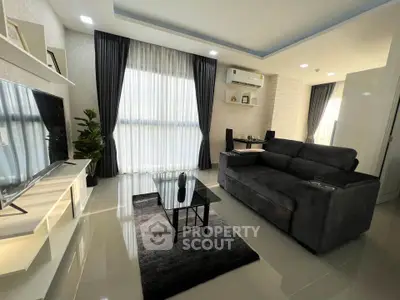 Modern living room with sleek furniture and large windows for natural light