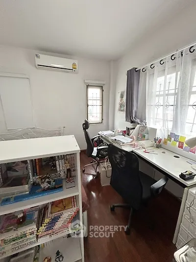 Cozy study room with ample natural light and organized workspace