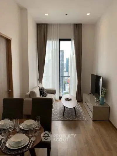 Modern living room with city view, stylish furniture, and elegant decor in a high-rise apartment.