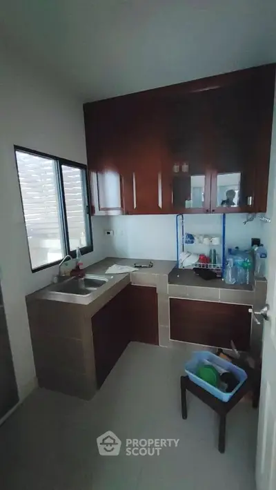Cozy kitchen with dark wood cabinets and modern sink setup