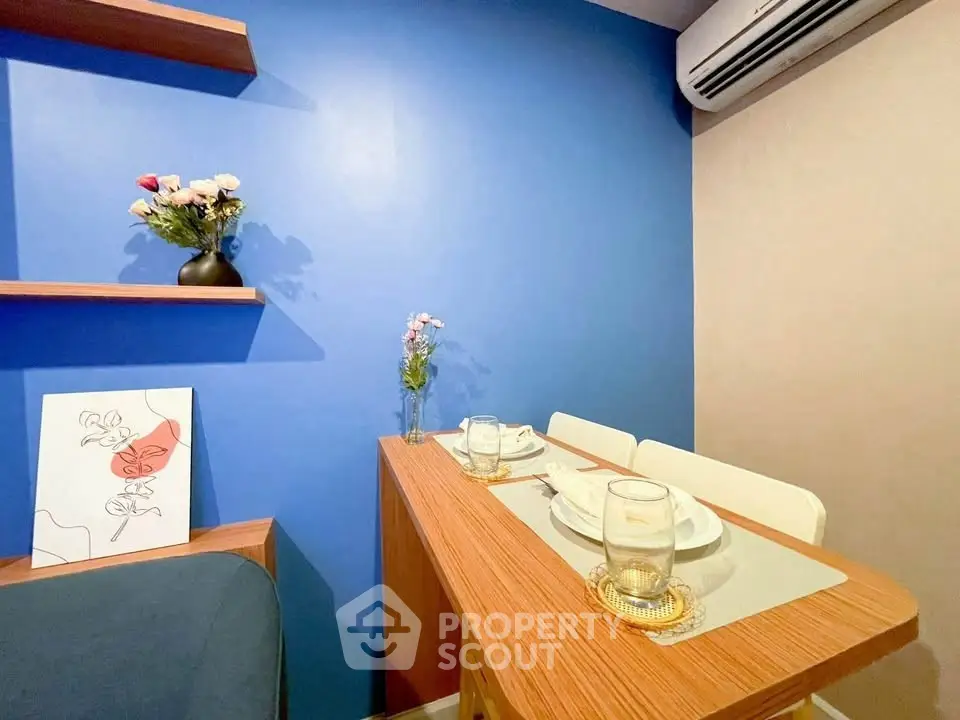 Chic modern dining nook with blue accent wall and stylish decor