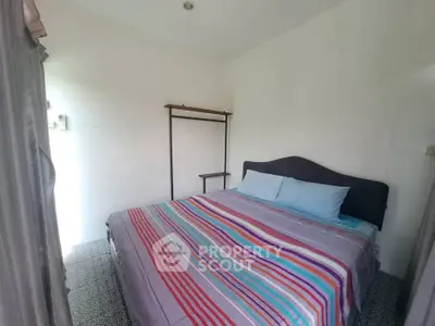 Cozy bedroom with colorful striped bedding and minimalist decor